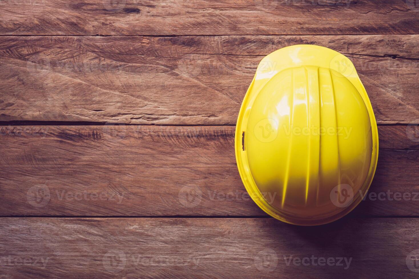 safty helmet placed on a wooden table photo