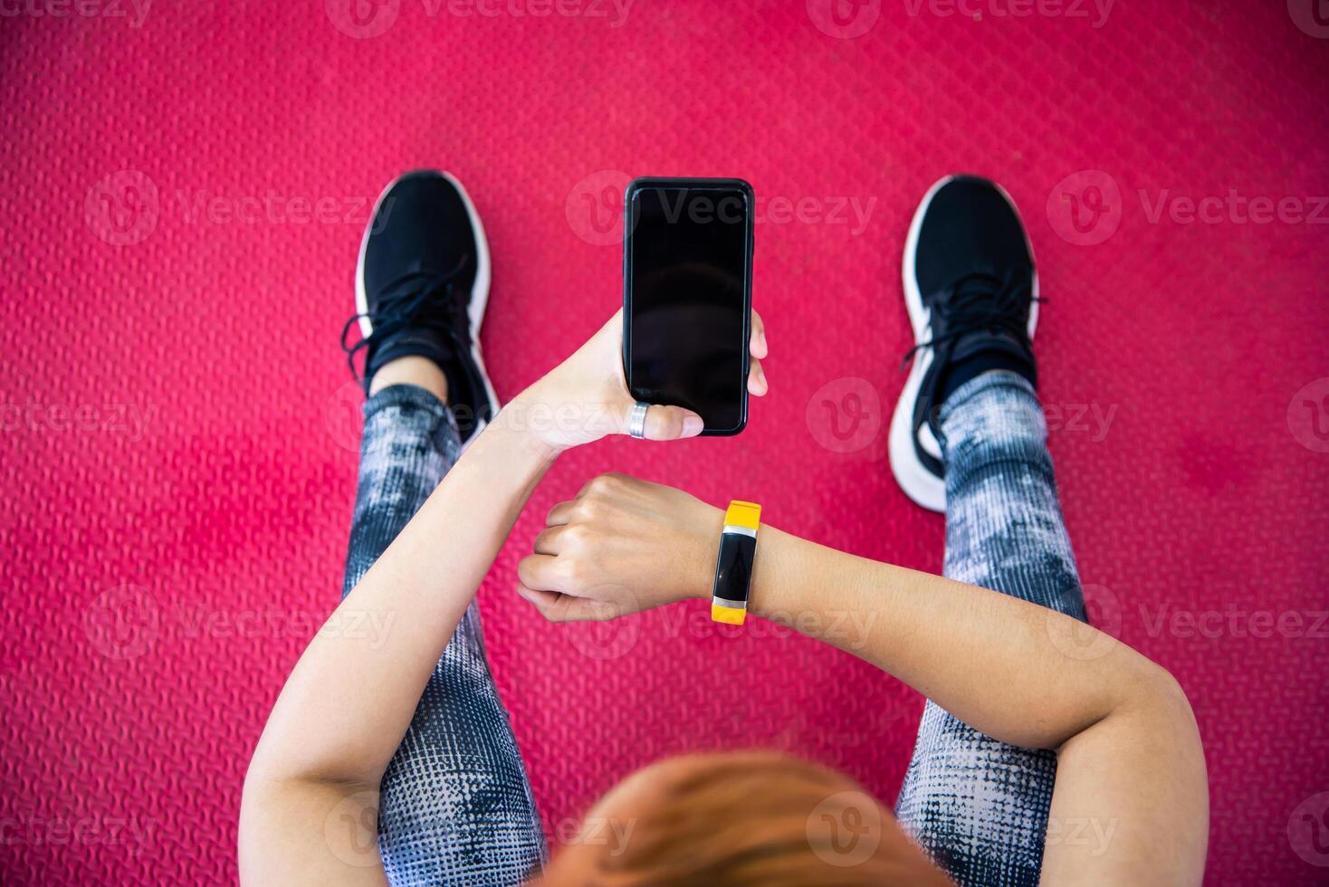 Woman in fitness clothing using smartphone. in gym for exercise photo