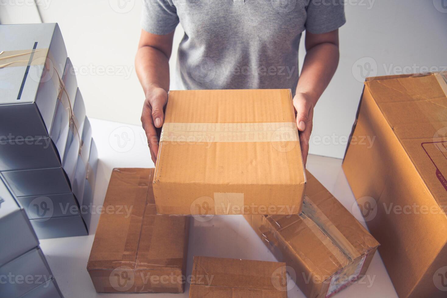 Hand holding closed-up tapes to pack products to prepare shipments. photo