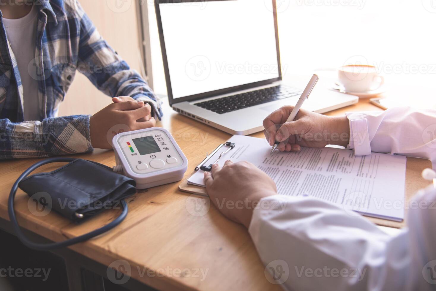 The doctor is discussing with the patient after a physical examination of the results and treatment guidelines. photo