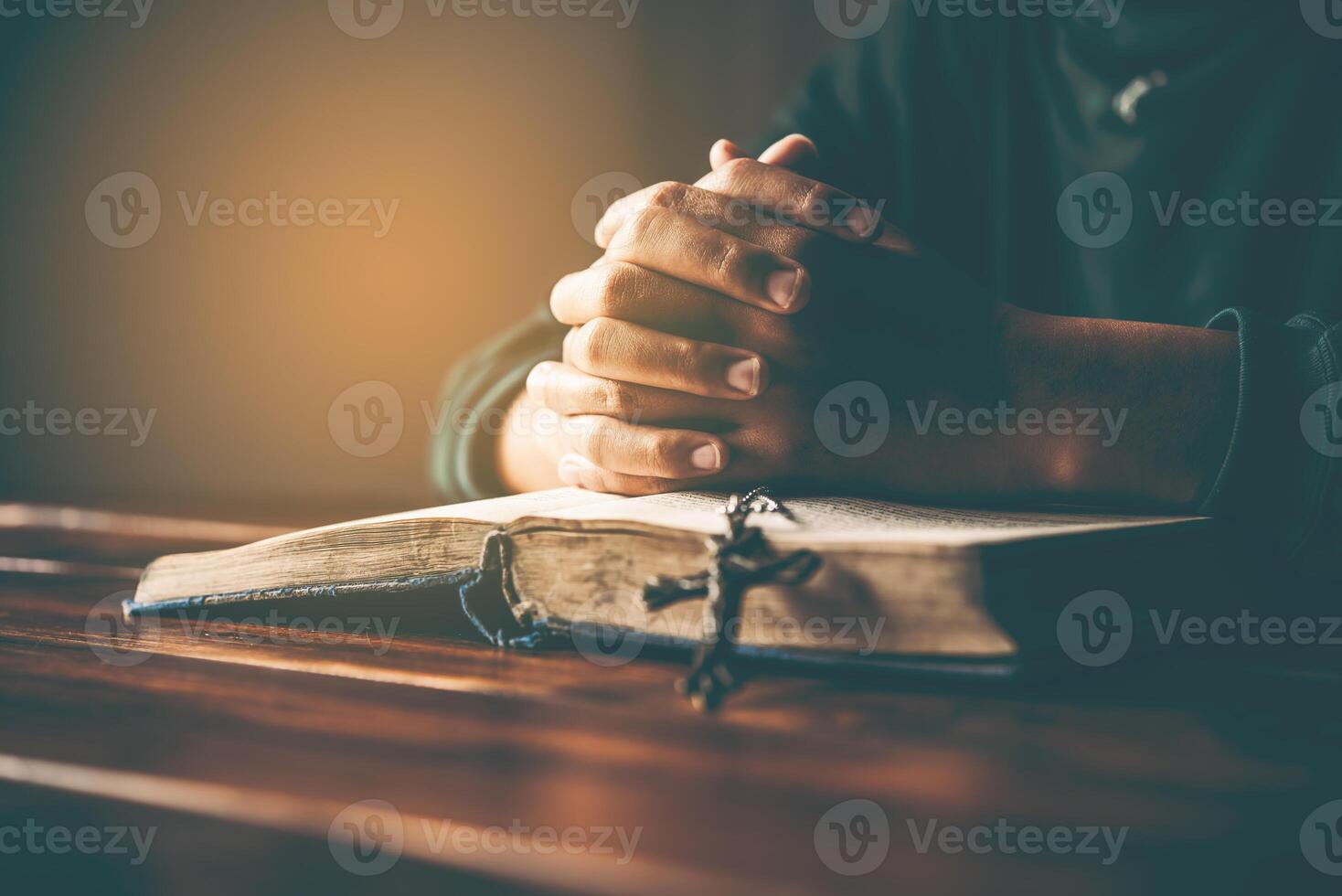 hands woman laying on the biblical while praying for christian religion blessings and Pray to God photo