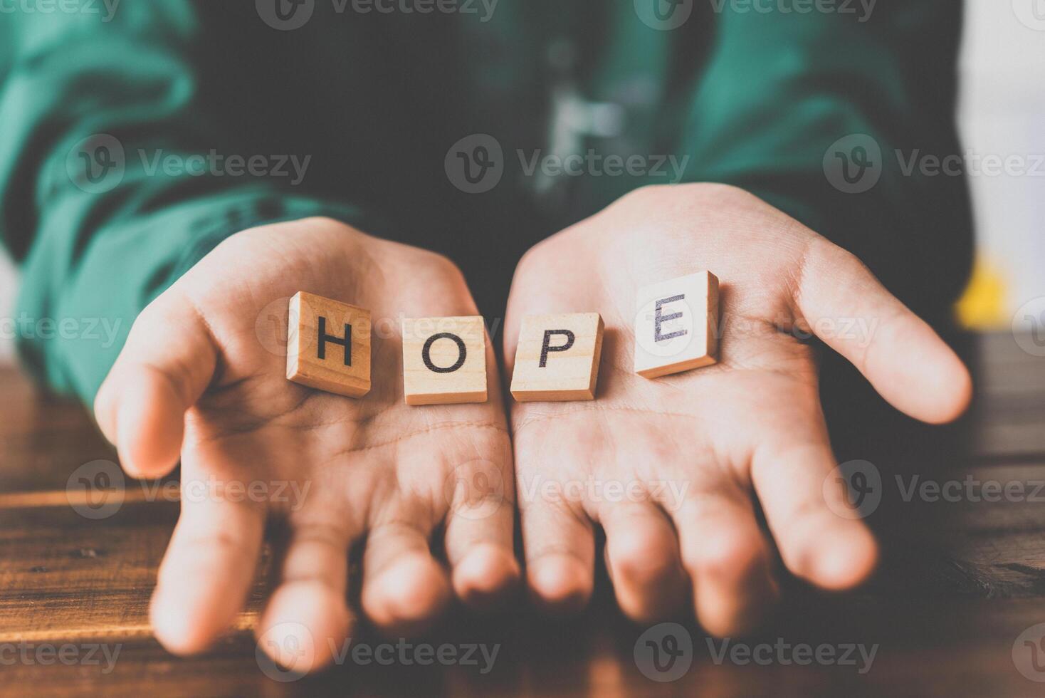 Human hands open palm of Christian and has the letter  HOPE  in hand photo