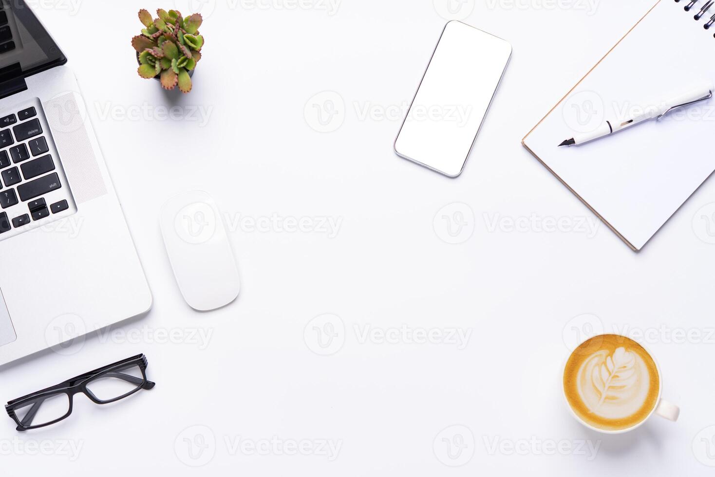 Top view with working desk with laptop,cellphone,notebook pencil coffee cup and eyeglasses in the office. photo