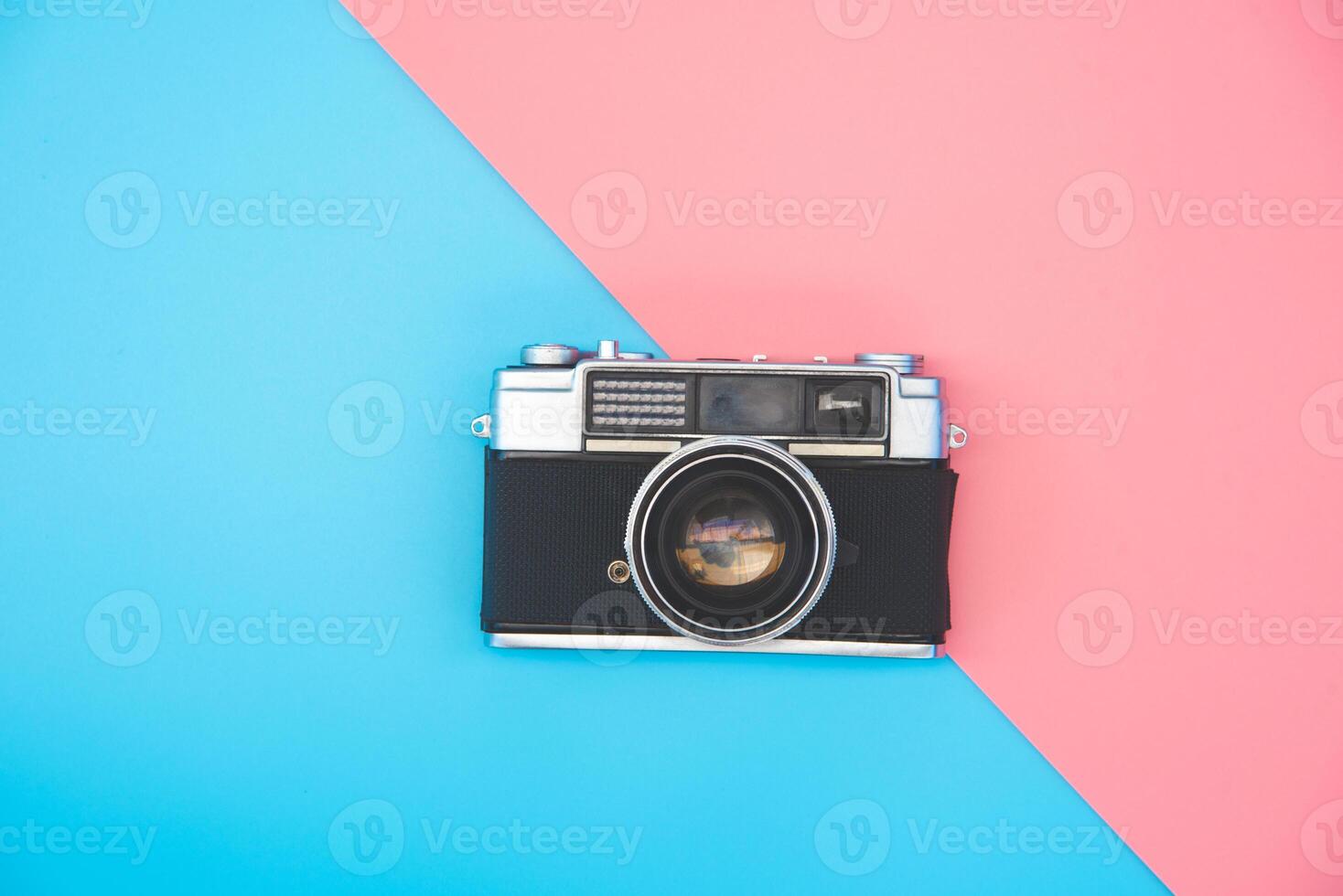 Old film camera placed in the color background photo