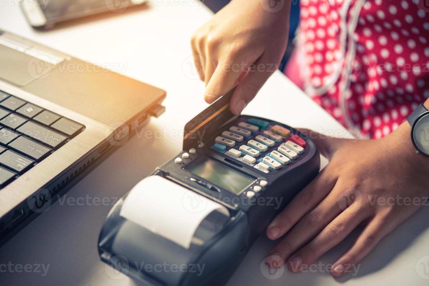 Paying by credit card , buying and selling products using a credit card swipe machine photo