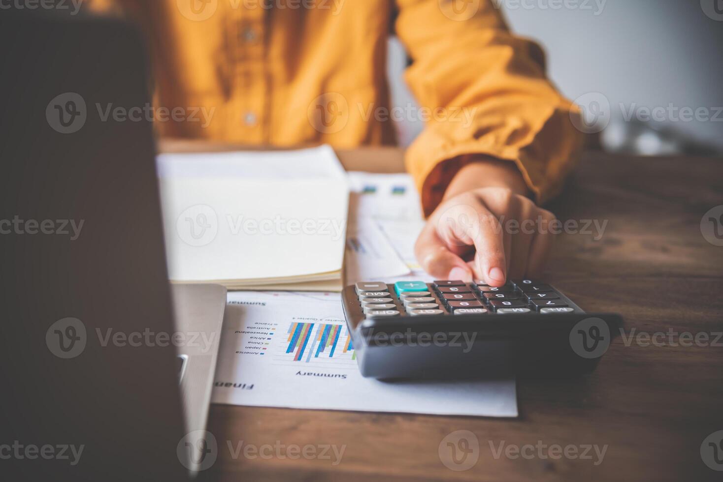 business person sitting at a desk at an office By using the calculator to work. Business Concept Analysis and Planning photo