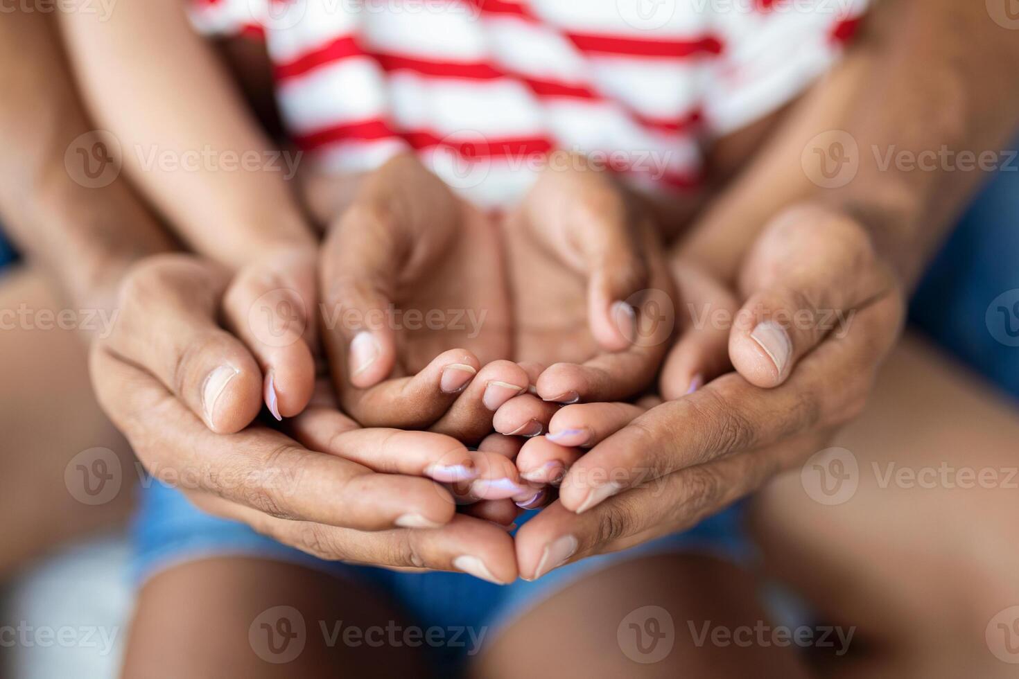 Parents and child placing their hands together, closeup shot photo
