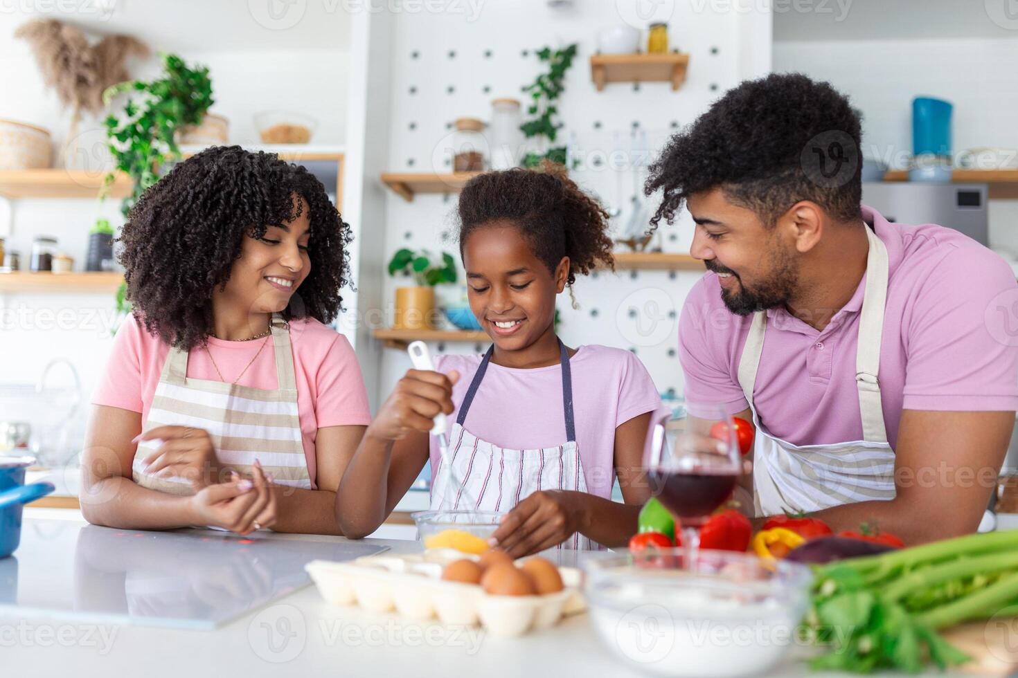 Family In Kitchen Making Morning Breakfast Together. Happy family in the kitchen having fun and cooking together. Healthy food at home. photo