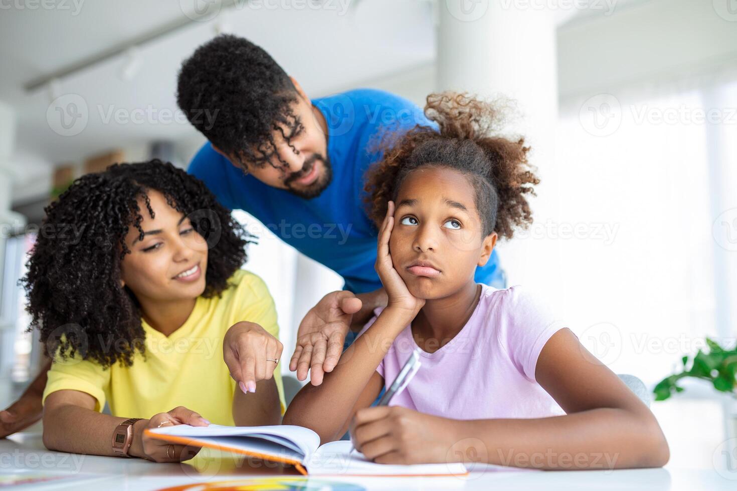 Young parents lecturing their daughter for bad behavior at school photo