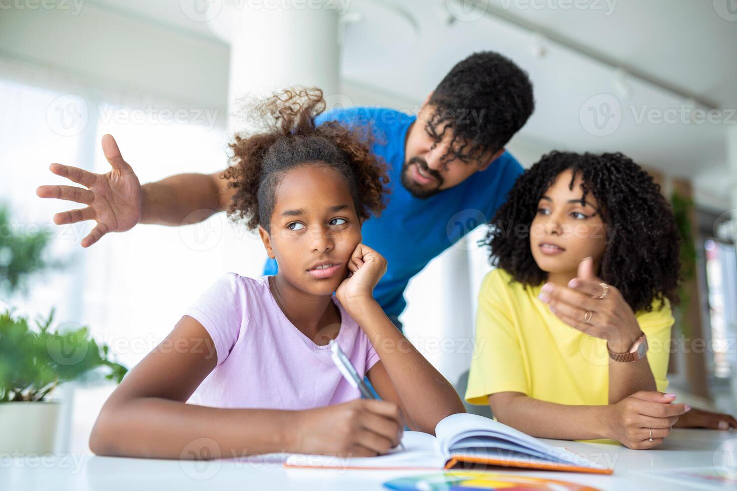 Young parents lecturing their daughter for bad behavior at school photo