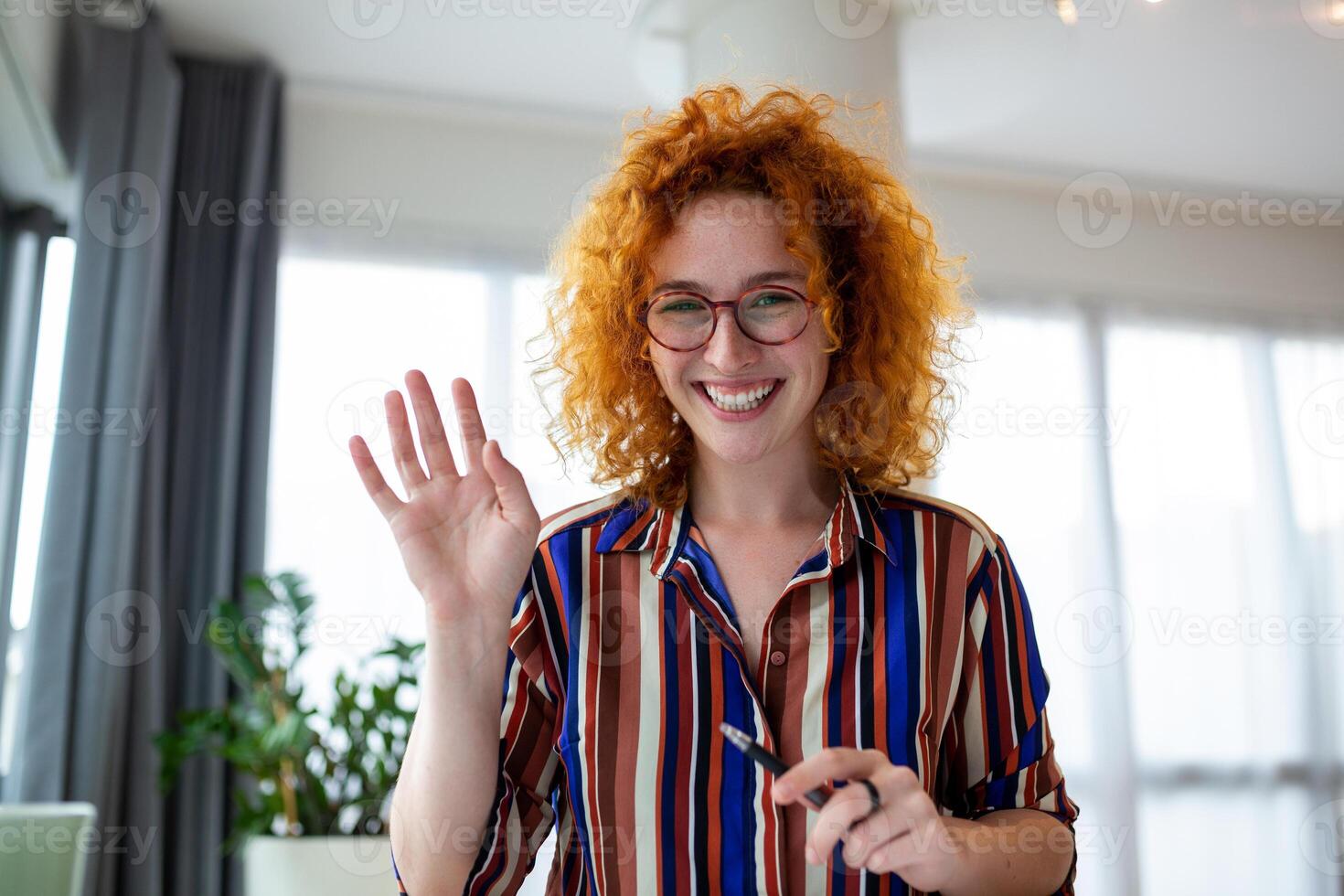 Shot of a businesswoman on a video call while sitting at her desk.Cropped shot of an attractive young woman using her laptop to make a video call at home photo