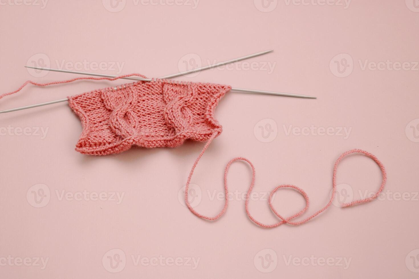 knitting element on pink background photo