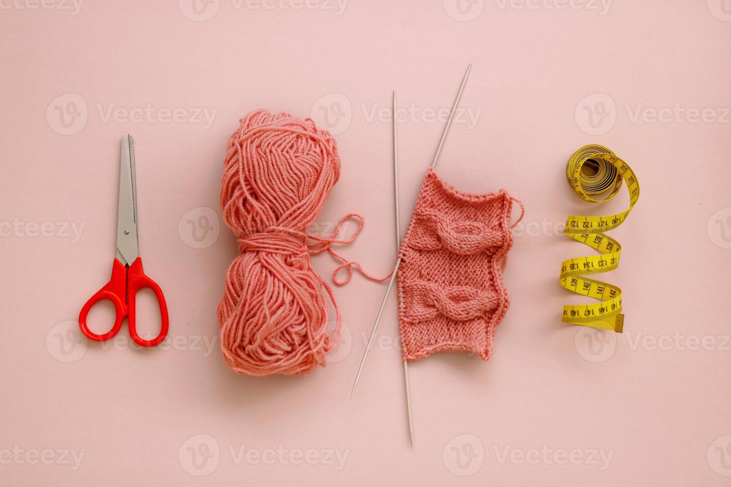 knitting accessories, scissors, skein of thread, knitting, centimeter laid out in a row photo