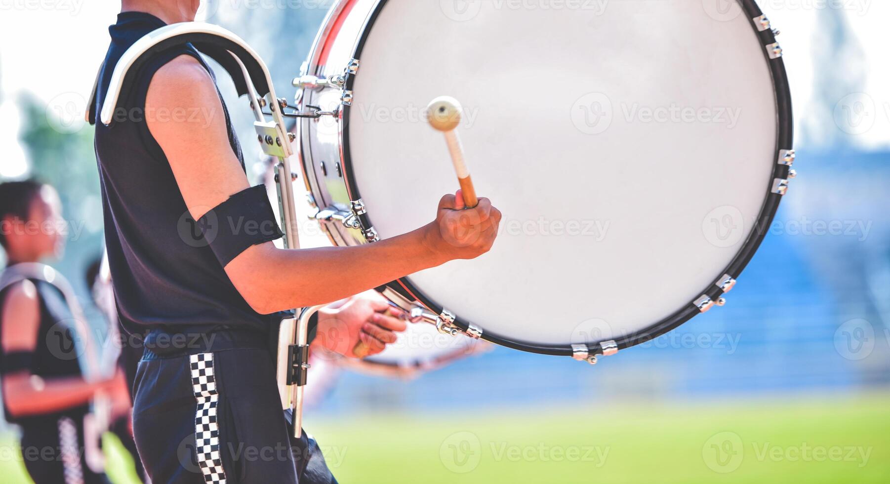 Close-up of marching band drummers marching photo