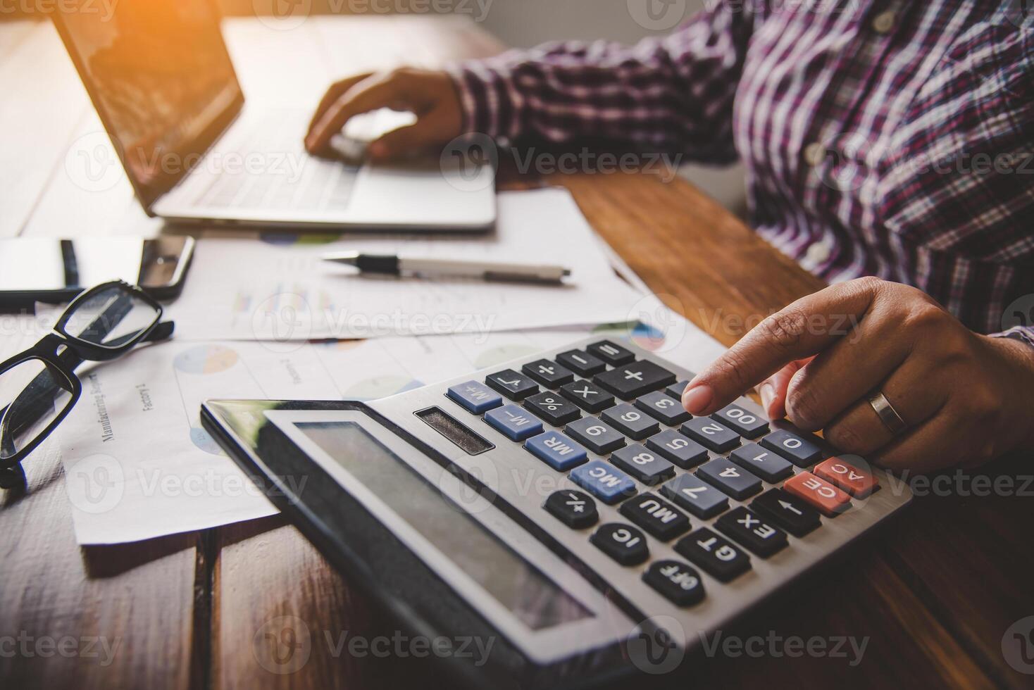 Businessman are working with a calculator and document. Meeting report in progress. in office business concept photo