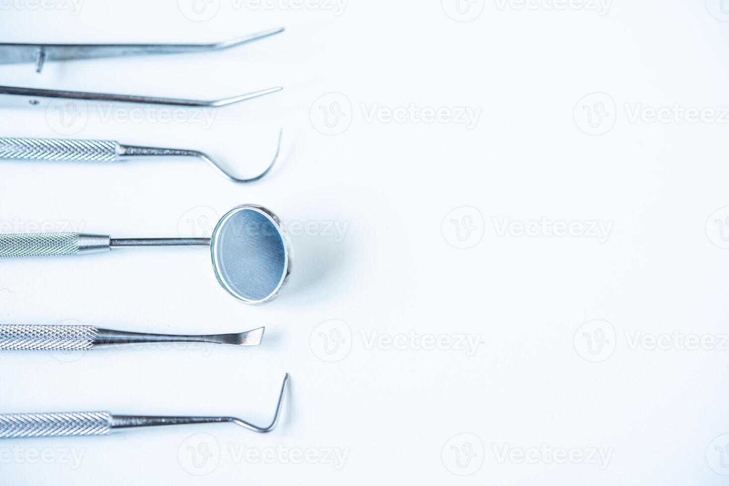 close up dentist  tools for teeth care at white background top view photo
