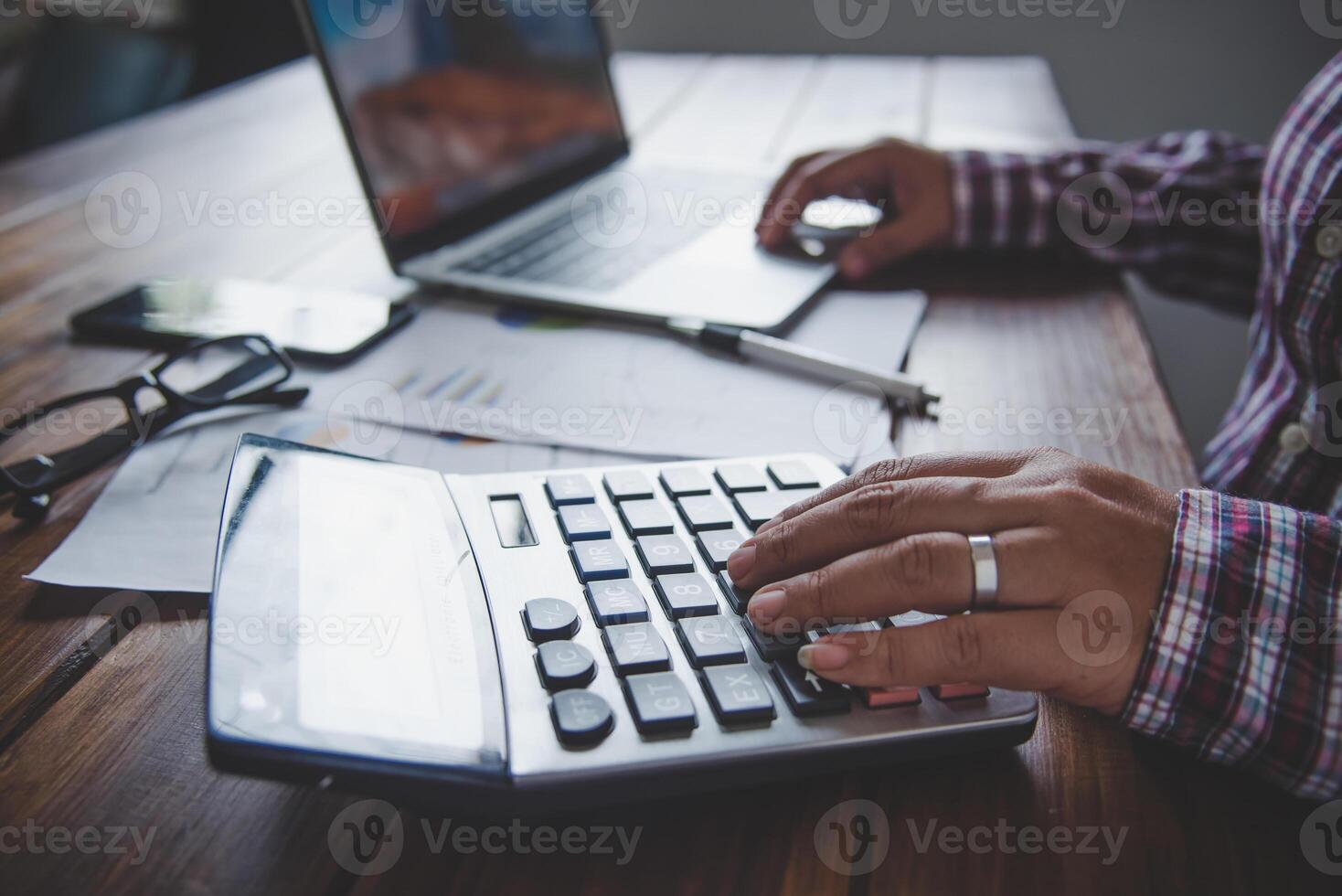 Businessman are working with a calculator and document. Meeting report in progress. in office business concept photo