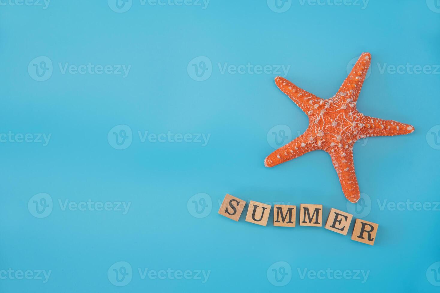 top view Simulated starfish and word SUMMER placed on a blue background concept summer travel photo