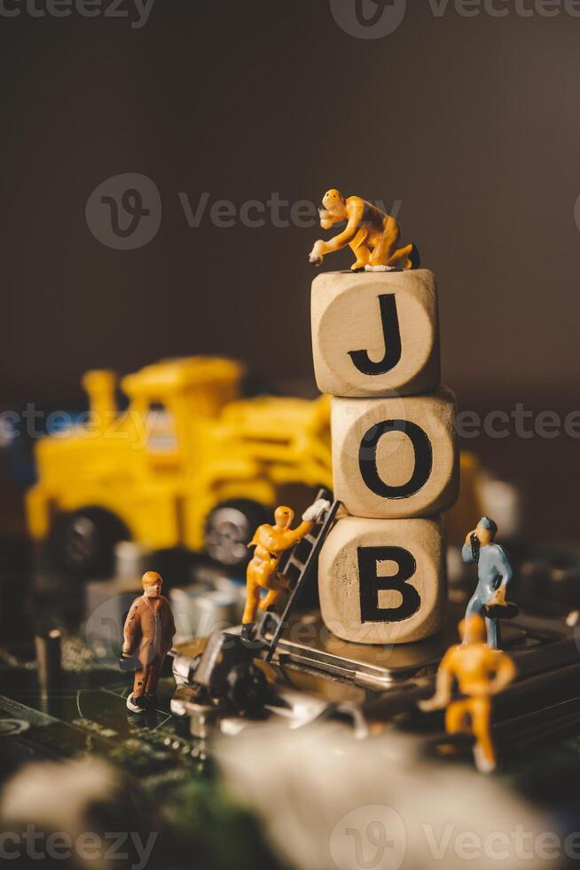 Miniature people or small figure worker on wood block with the word job. Working for an organization concept. photo