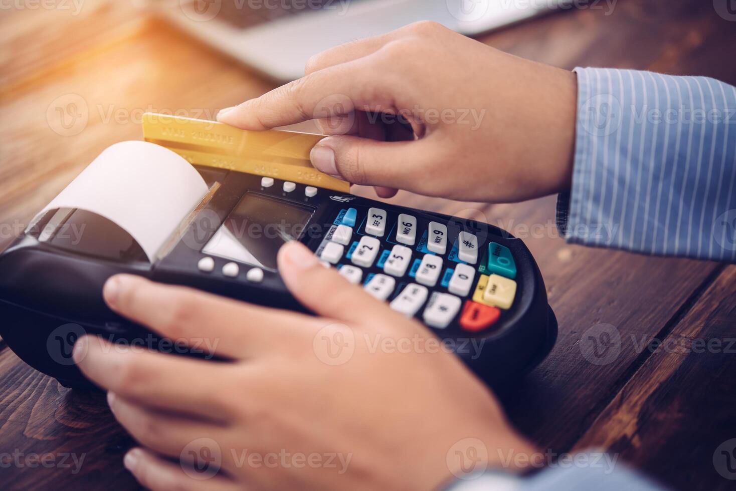 Paying by credit card , buying and selling products using a credit card swipe machine photo