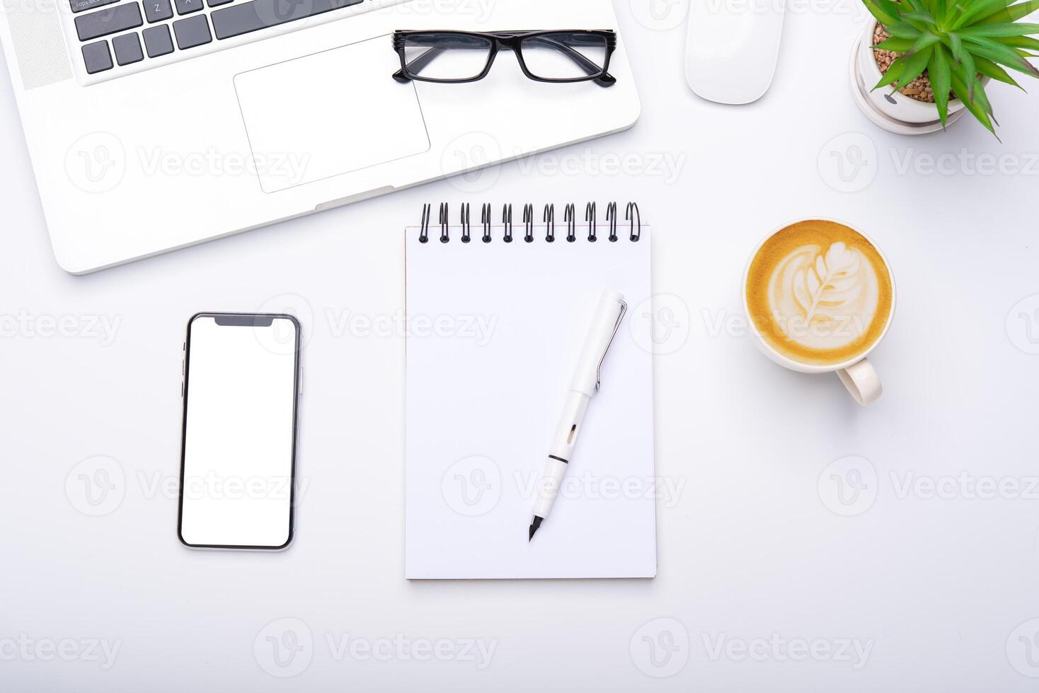 Top view with working desk with laptop,cellphone,notebook pencil coffee cup and eyeglasses in the office. photo