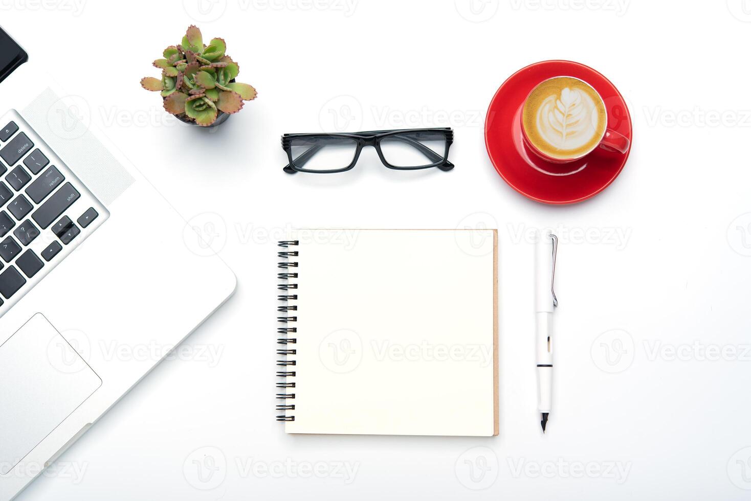 Top view with working desk with laptop,cellphone,notebook pencil coffee cup and eyeglasses in the office. photo