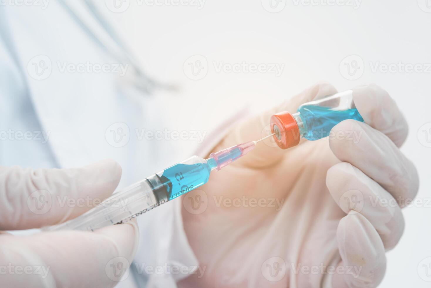 Doctor with syringe ready for injection of vaccine to patient. Vaccination concept. photo
