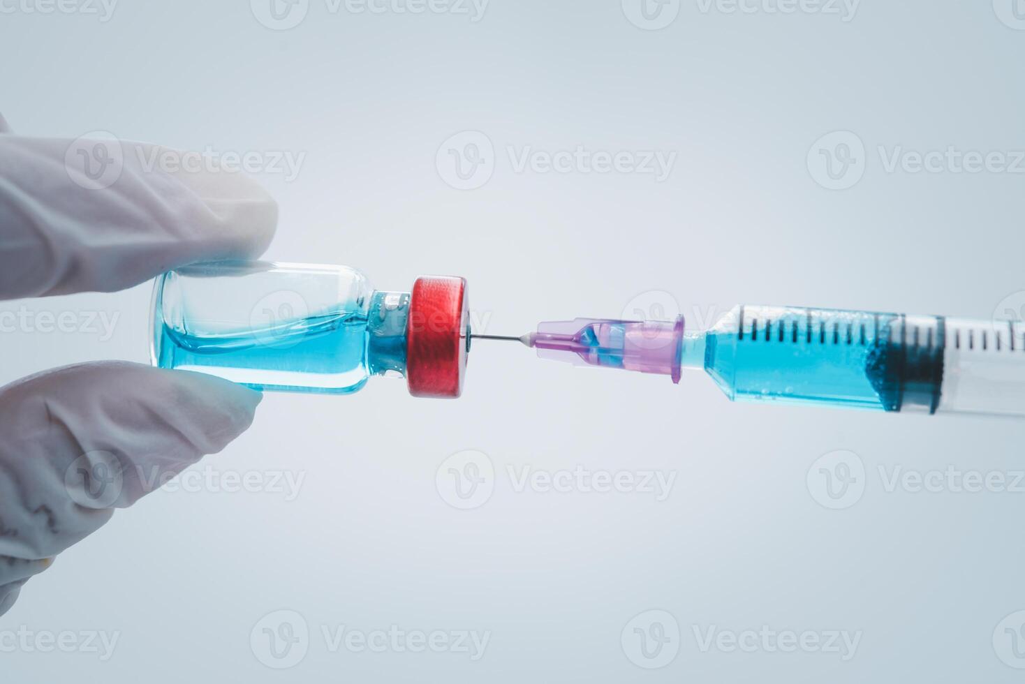 close-up doctor with syringe ready for injection of vaccine to patient. Vaccination concept. photo