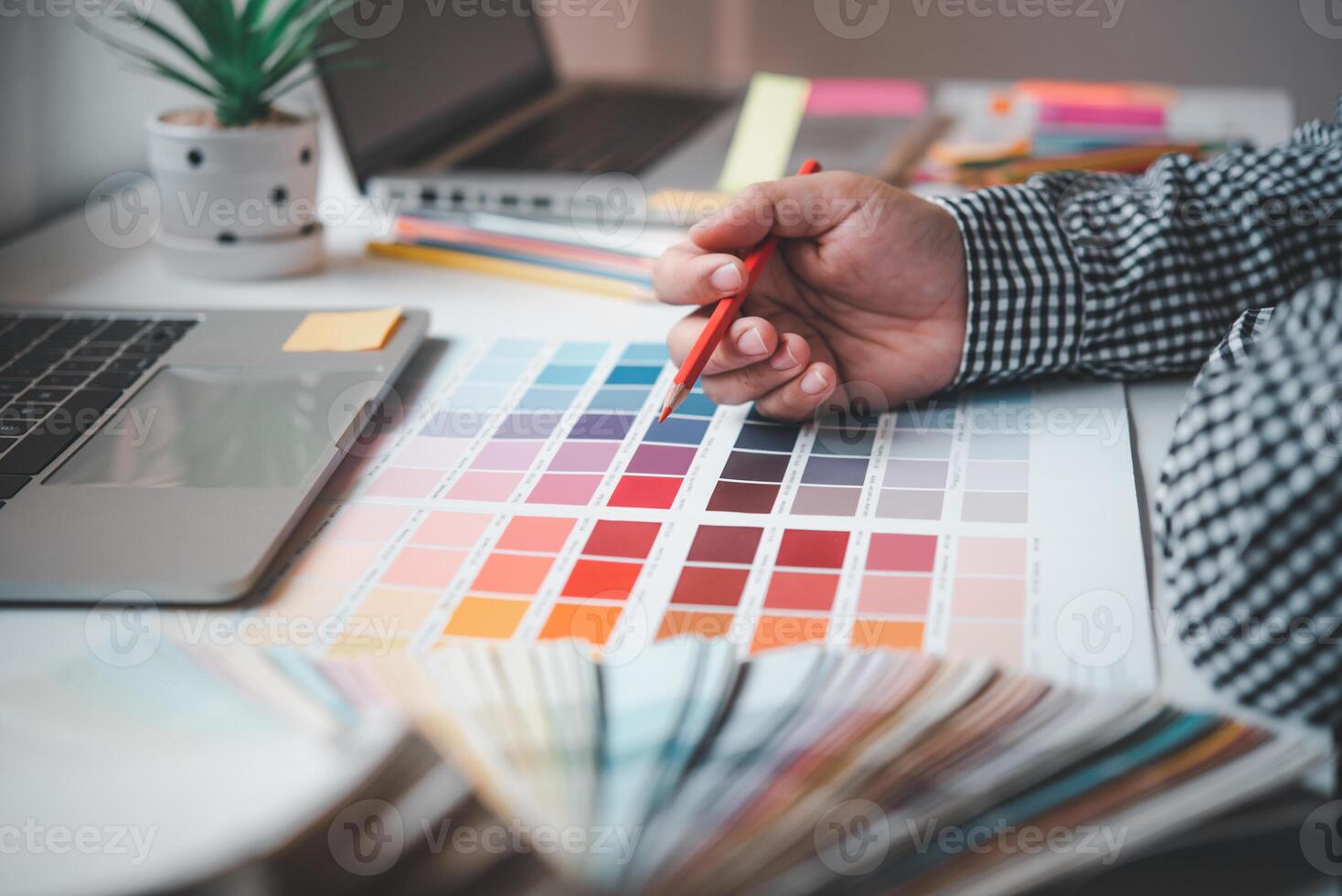 The graphic designer creative team is currently working on the design and color selection on the guide color for advertising design. photo