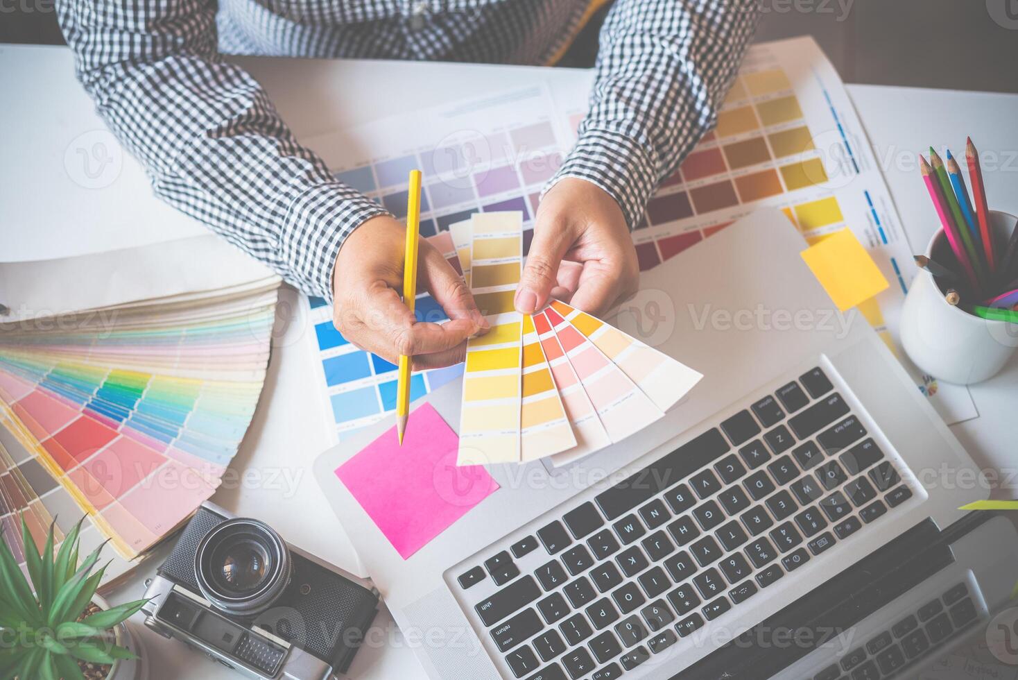 The graphic designer creative team is currently working on the design and color selection on the guide color for advertising design. photo