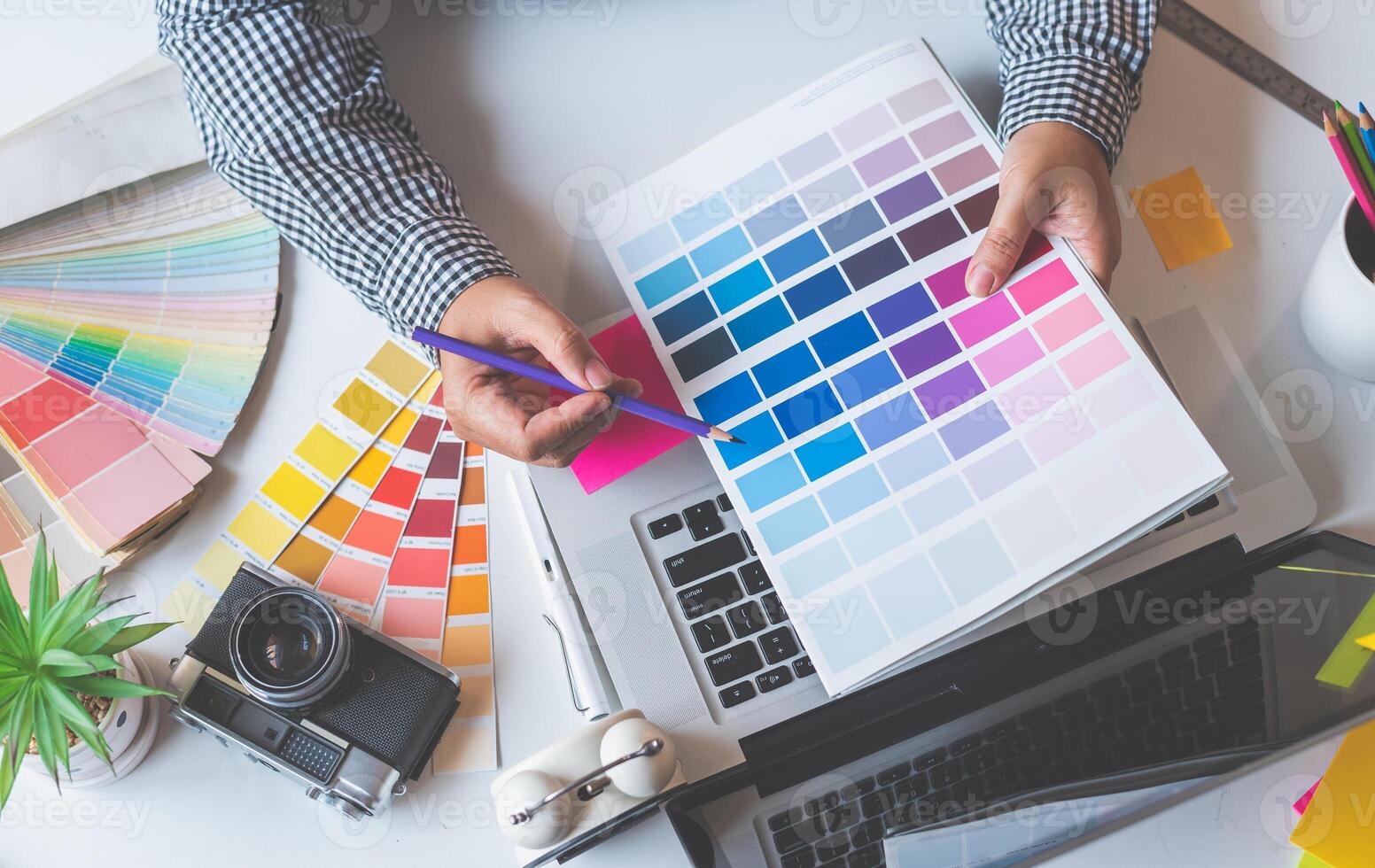 The graphic designer creative team is currently working on the design and color selection on the guide color for advertising design. photo