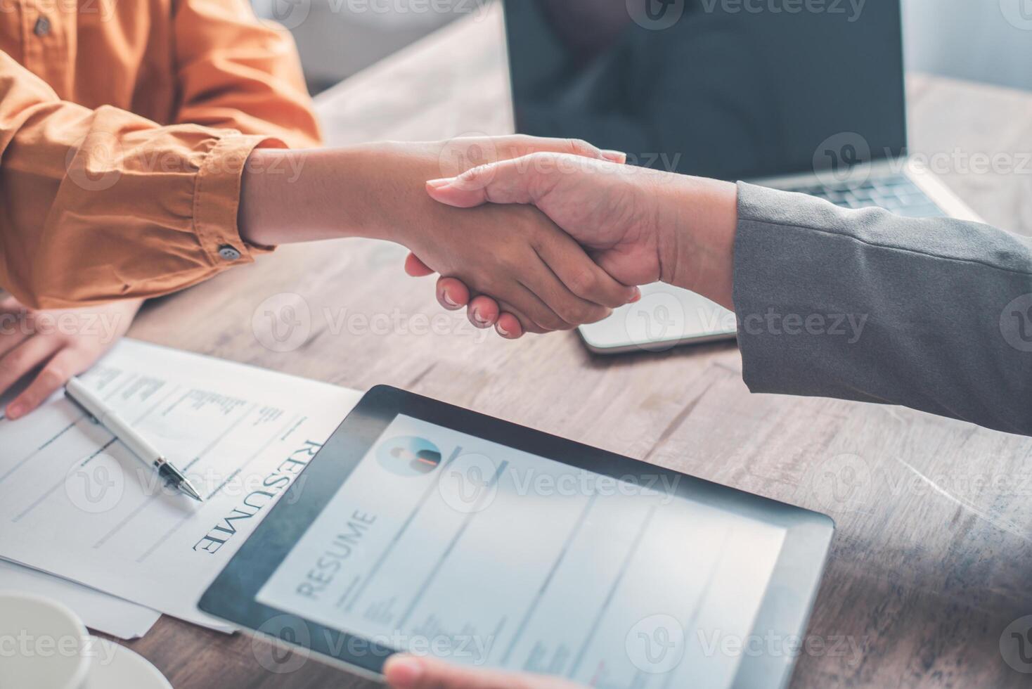 HR managers join hands with job applicants, accept proposals and agree to work together in the company. photo