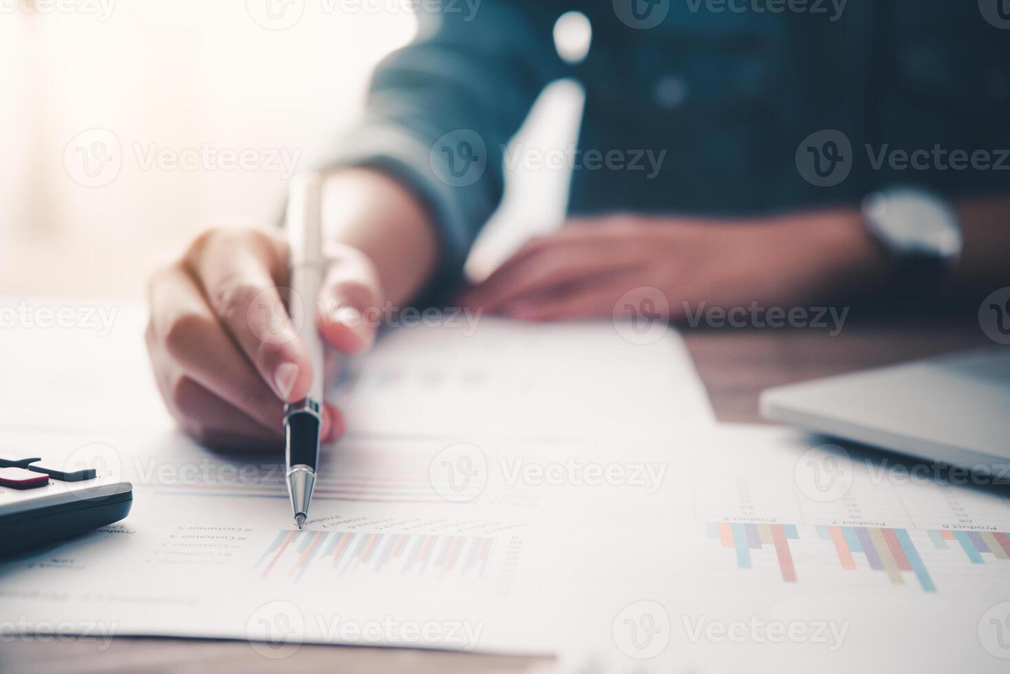 businessman pointing with pen on business report chart are working on accounts in business analysis with graphs and documentation. photo