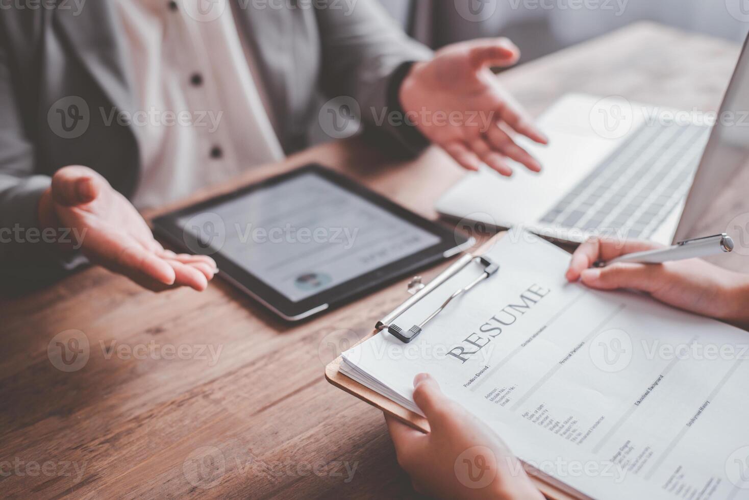 Human resource manager Is explaining the job to the job seeker before filling out a resume on the application form to consider accepting for employment in the company. photo