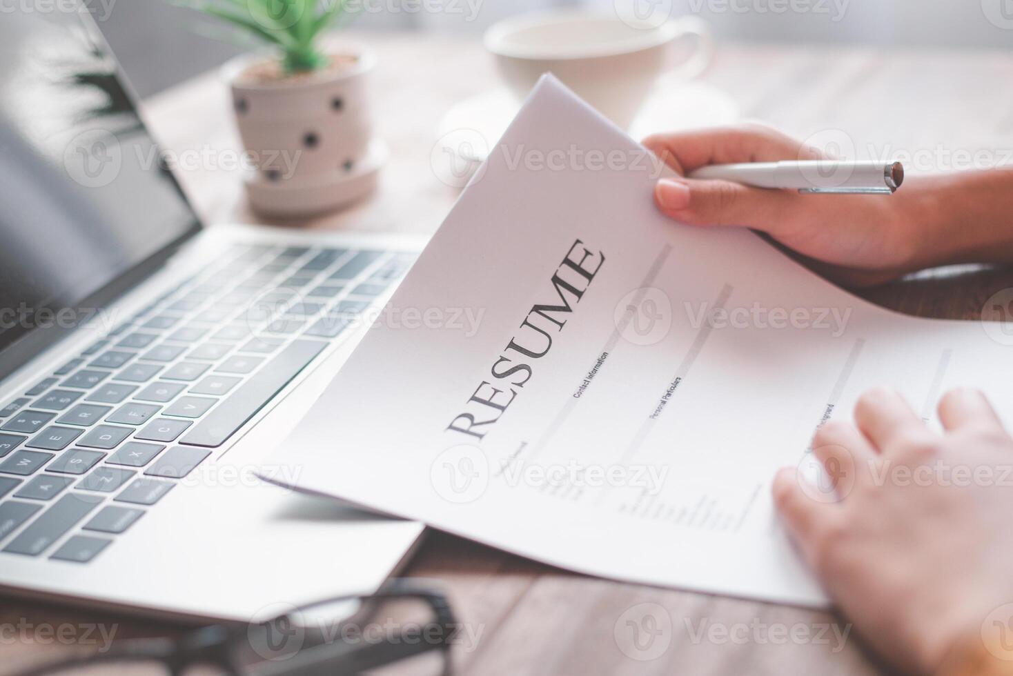 People are reviewing job applications before filling out their resume on the job application form in order to apply for a job at a company. photo