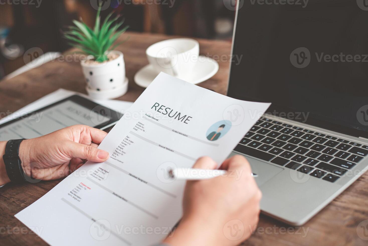 People are reviewing job applications before filling out their resume on the job application form in order to apply for a job at a company. photo