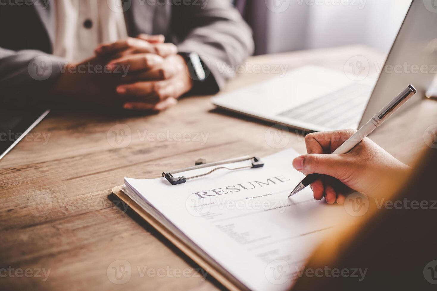Human resource manager Is explaining the job to the job seeker before filling out a resume on the application form to consider accepting for employment in the company. photo