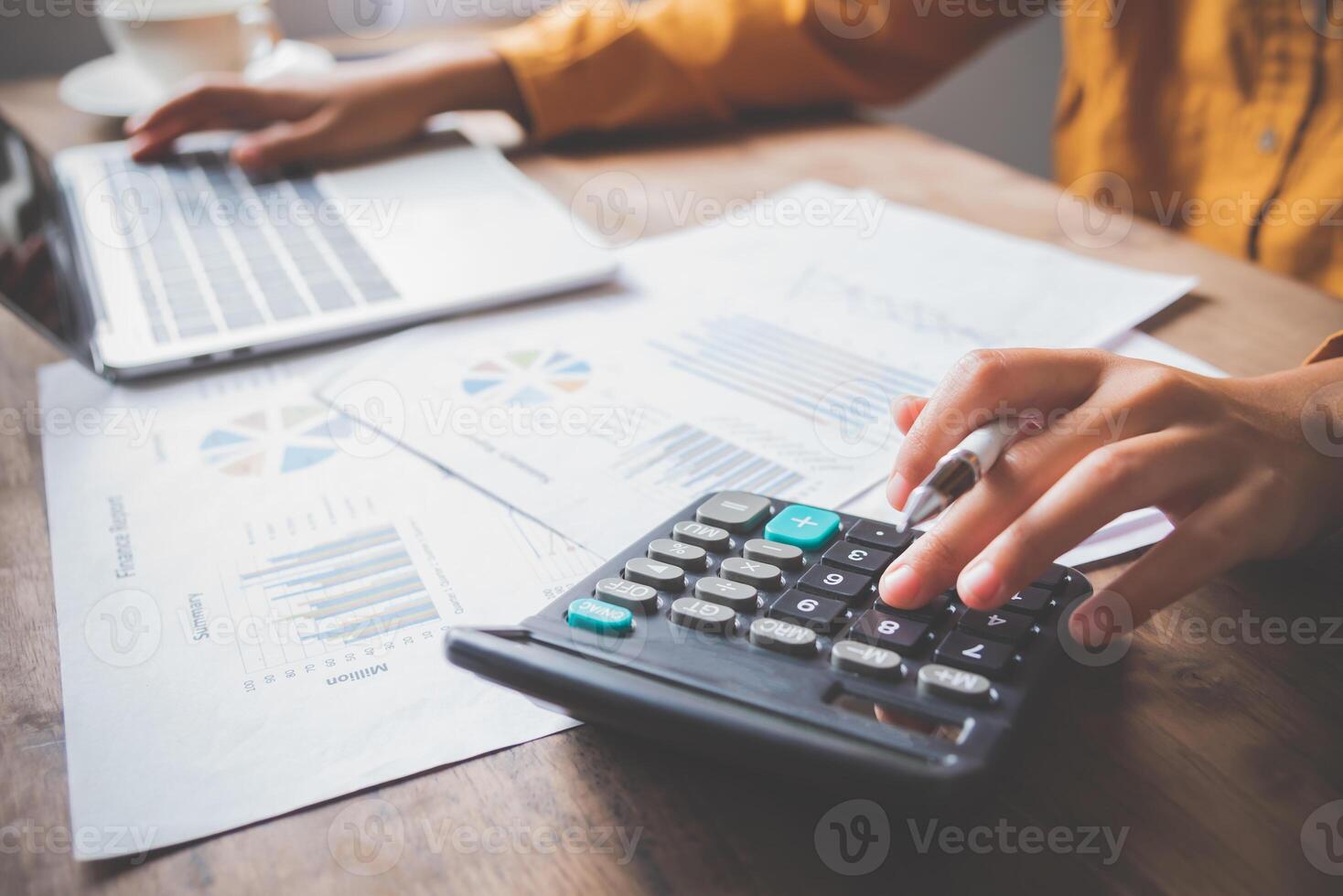 business person sitting at a desk at an office By using the calculator to work. Business Concept Analysis and Planning photo
