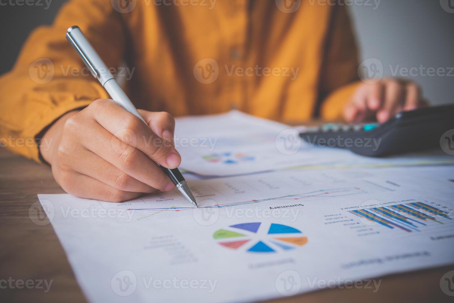 businessman pointing with pen on business report chart are working on accounts in business analysis with graphs and documentation. photo