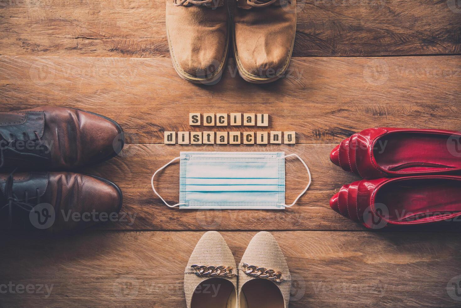 Men and women shoes laid on wooden floors, concept social distancing during the epidemic disease covid-19 photo