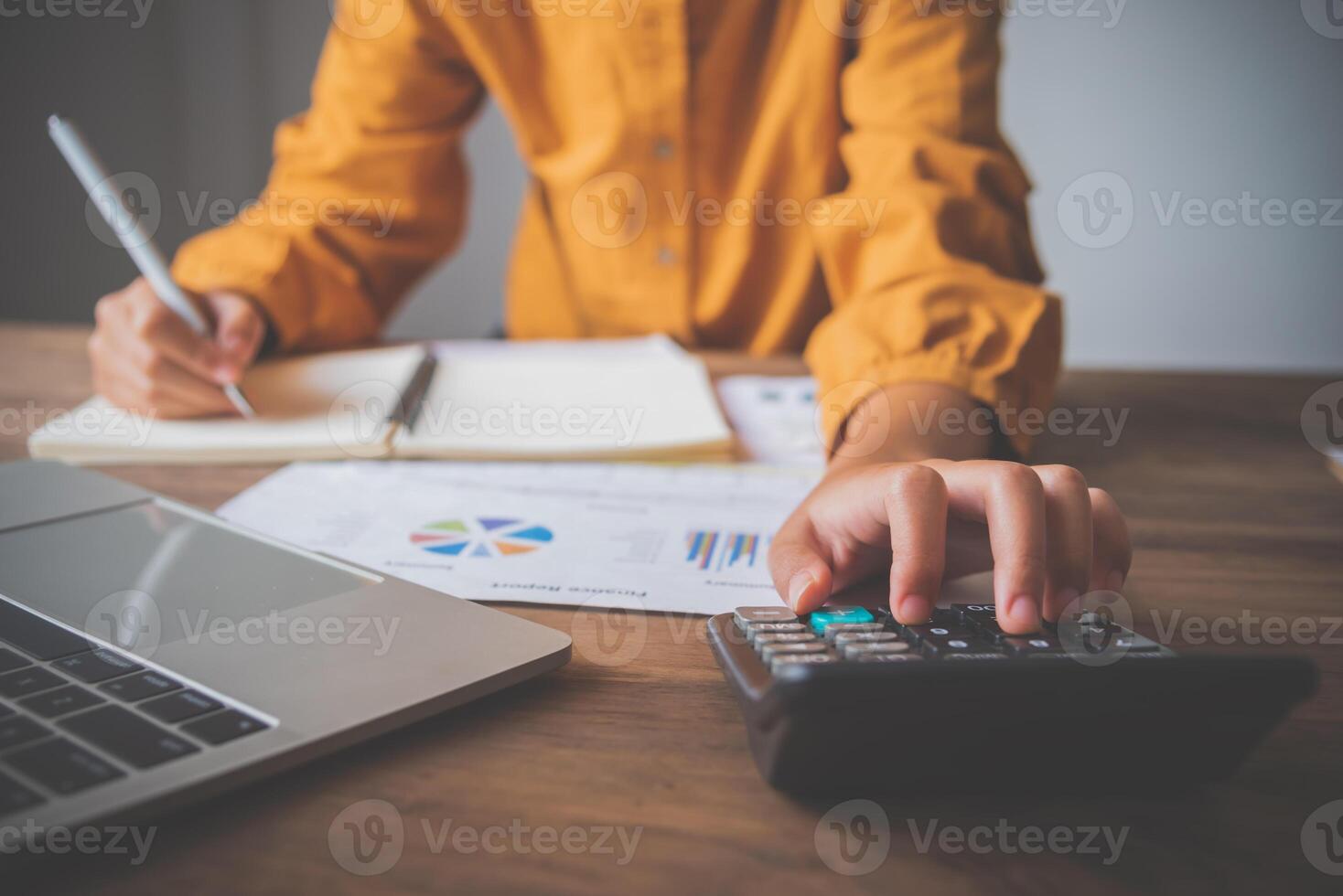 business person sitting at a desk at an office By using the calculator to work. Business Concept Analysis and Planning photo