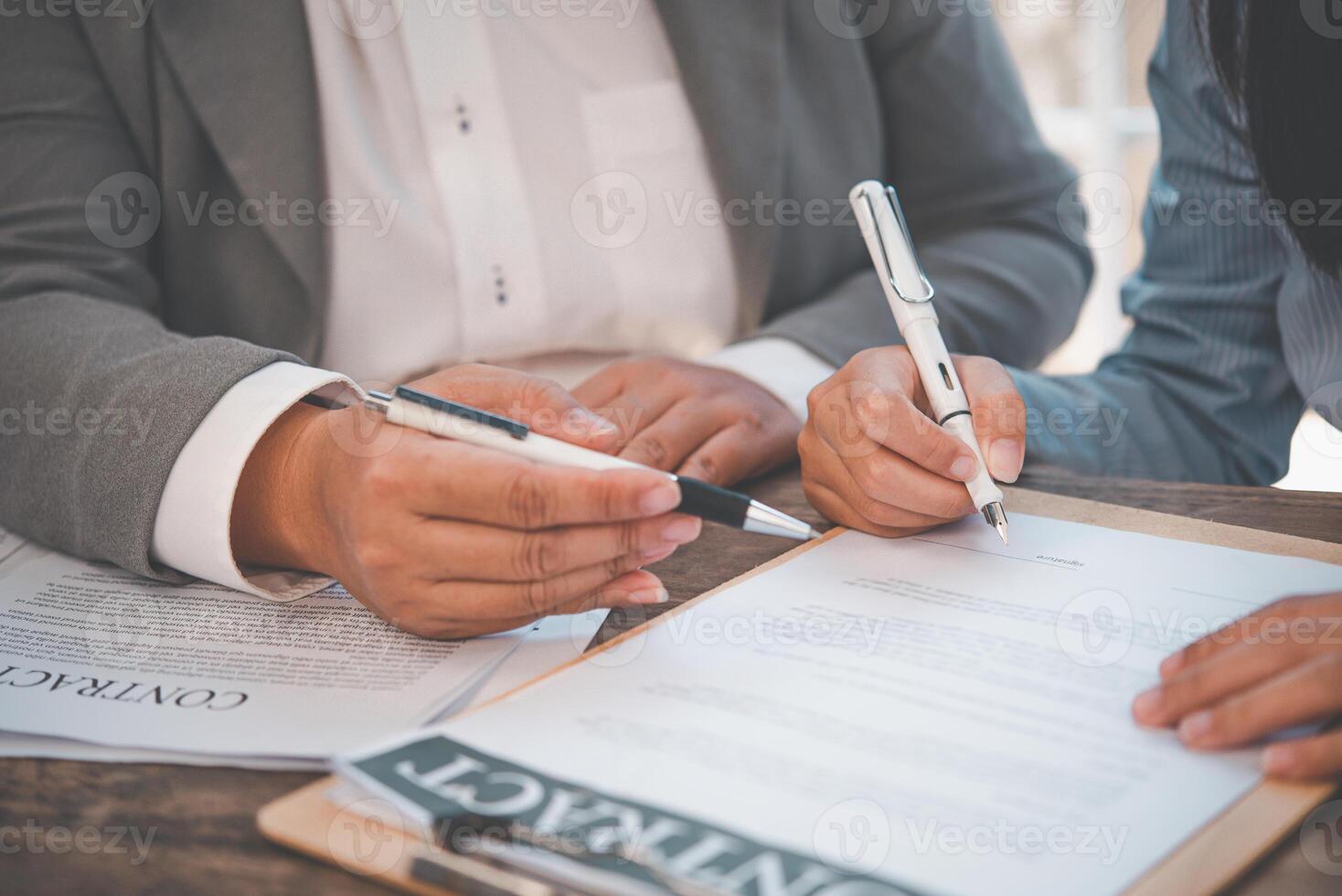 businessman is negotiating, advising, and explaining the matter of the contract to be agreed to sign the contract. photo