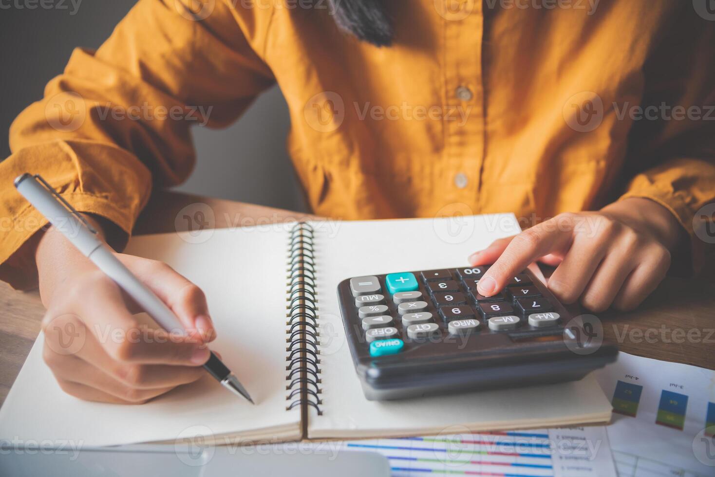 business person sitting at a desk at an office By using the calculator to work. Business Concept Analysis and Planning photo