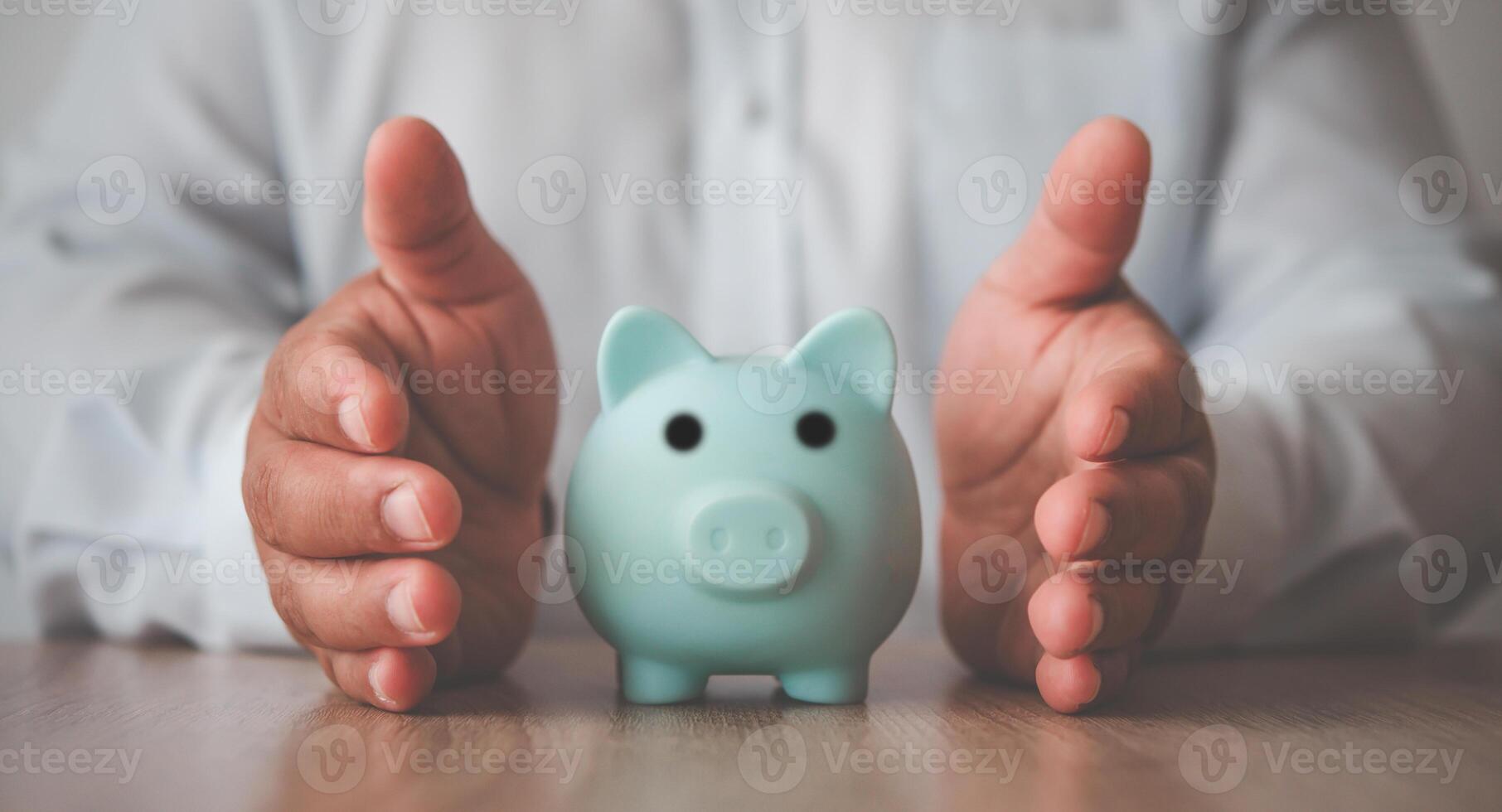 Hand protecting the icon piggy bank - the concept of insurance for Deposit photo
