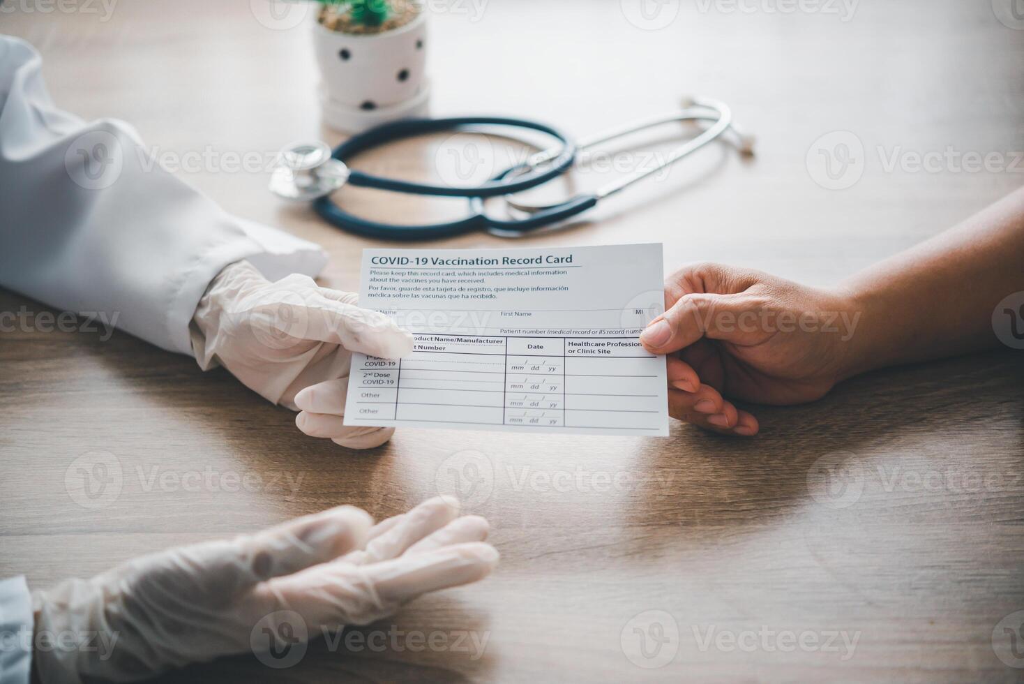 Doctors are writing in coronavirus vaccination card for people who come to the Covid-19 vaccination service.concept of defeating and preventing Covid-19. photo