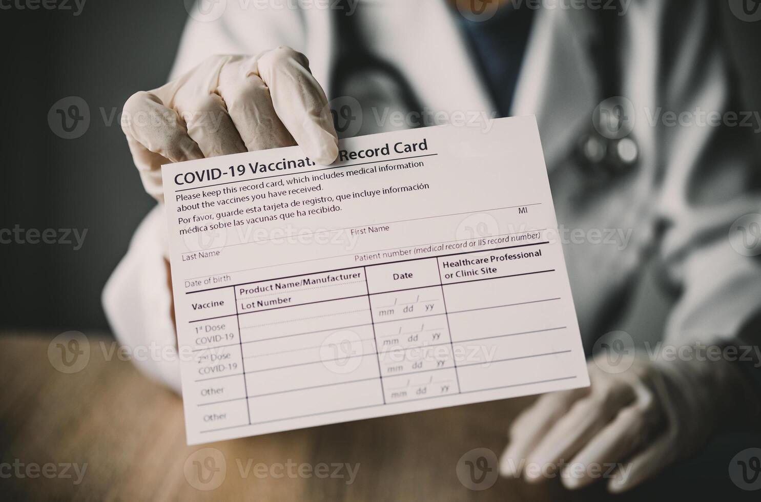 Coronavirus vaccination record card in the hands of a doctor to a patient who has already been vaccinated with Coronavirus. .Coronavirus prevention photo