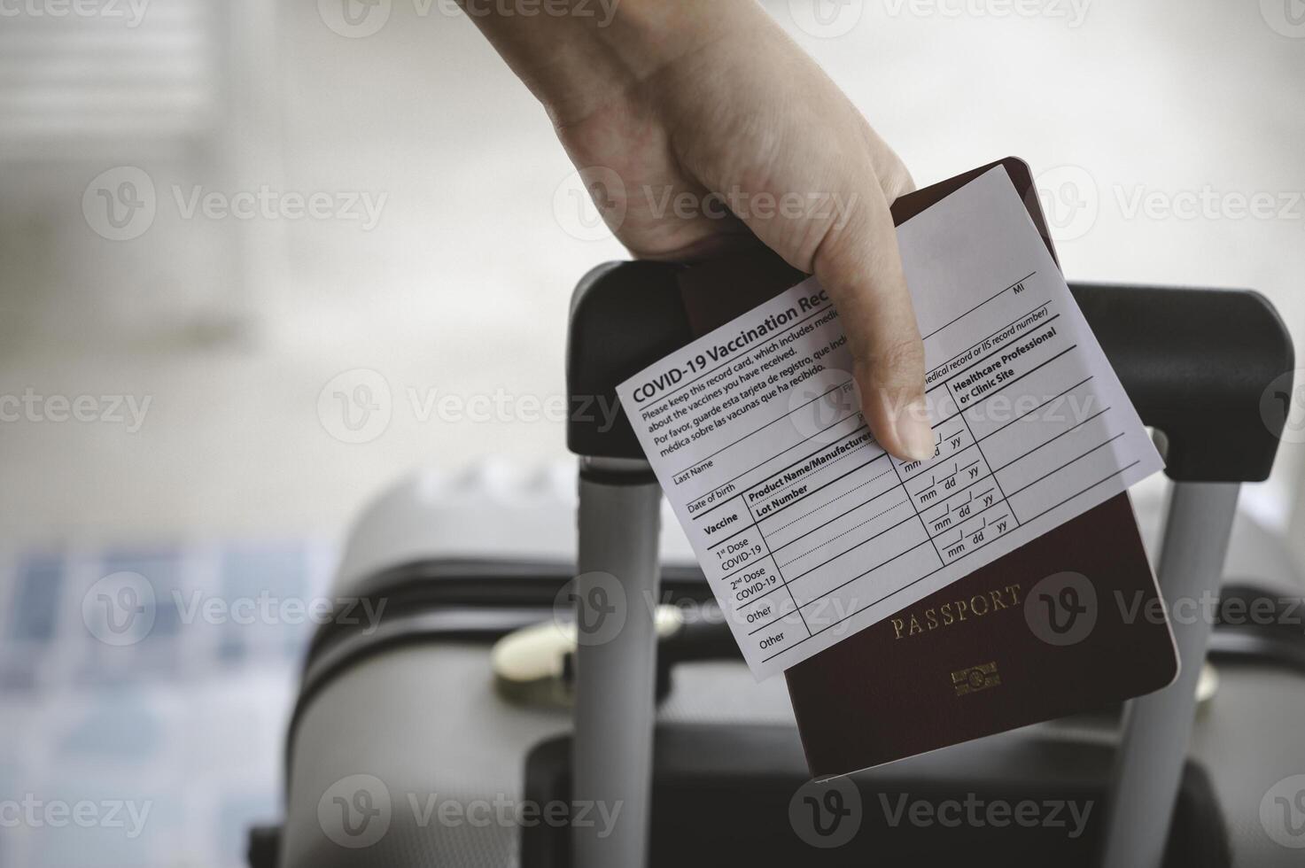 People holding passports and coronavirus vaccination card, map for travel with luggage for the trip. Covid-19 around the world photo