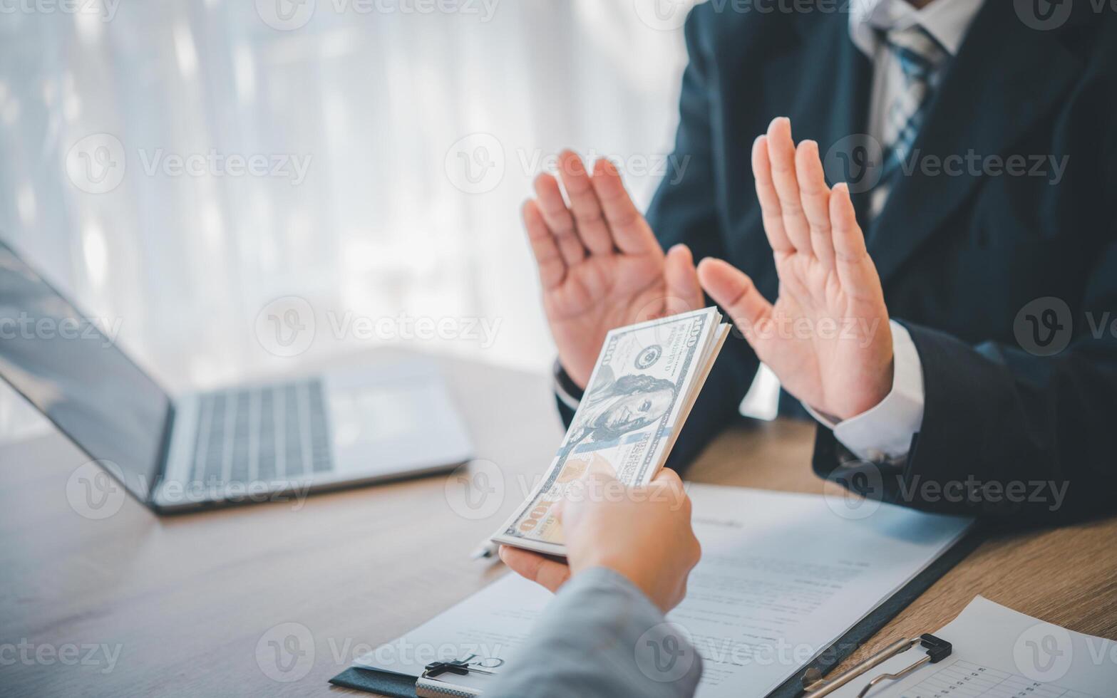 Dollar bills are not accepted as bribes by businesspeople. Concepts of anti-bribery and anti-corruption photo