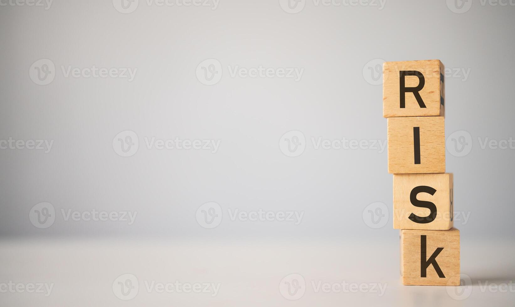 wooden block with the word RISK. Concept risk management photo