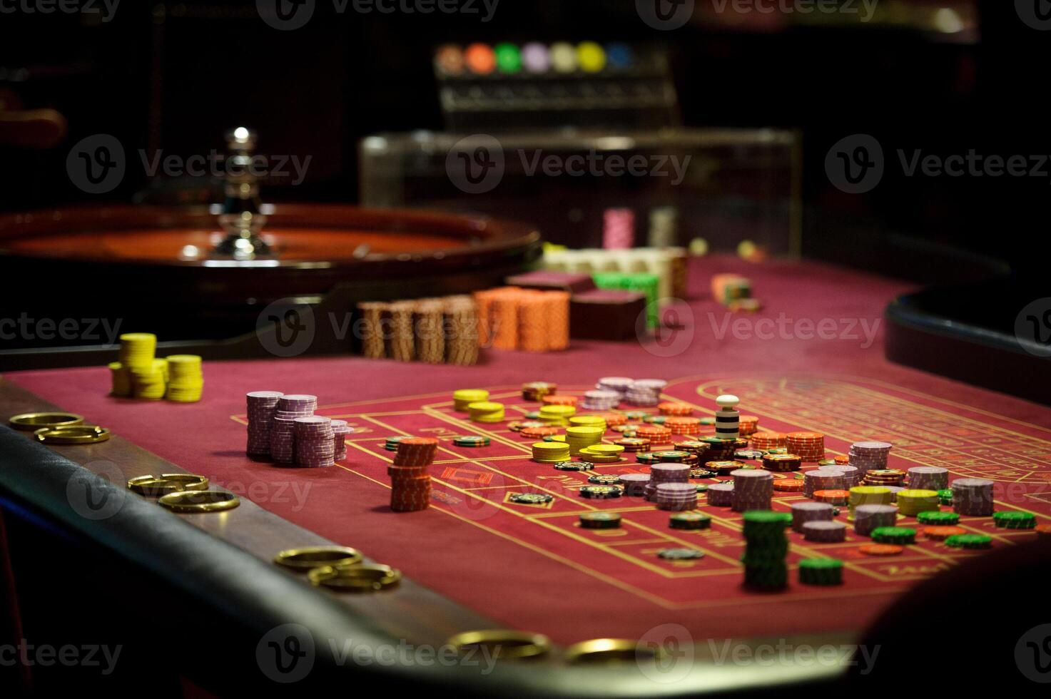close-up chips and roulette at the casino on the red table photo